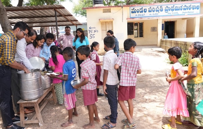 Mr. Sujnan Venkatesh, Senior Vice President and Head of HR ADP Pvt Ltd serving meals to the children